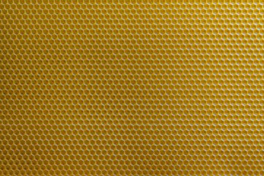 Bal dolu bir arı kovanından alınan balmumu bal peteğinin arka plan dokusu ve şablonu. Voshchina bal peteği yapımında yapay bir temel, hücrelerin balmumu tabakası