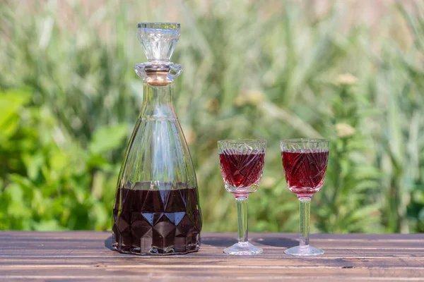 Homemade Cherry Brandy Glasses Glass Bottle Wooden Table Summer Garden — Stockfoto