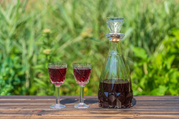 Homemade Cherry Brandy Glasses Glass Bottle Wooden Table Summer Garden — Foto Stock