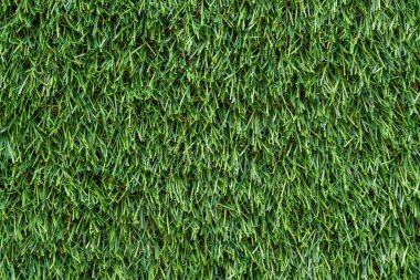 Arkaplan veya doku için kullanılan yapay yeşil çimenleri kapat