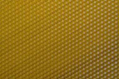 Bal dolu bir arı kovanından alınan balmumu bal peteğinin arka plan dokusu ve şablonu. Voshchina bal peteği yapımında yapay bir temel, hücrelerin balmumu tabakası