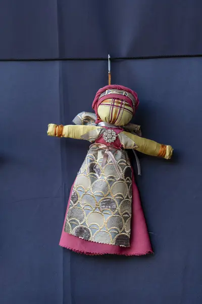 Close-up of a traditional amulet doll for sale to tourists at a street market in Kyiv, Ukraine. Ukrainian motanka dolls
