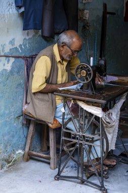 Devpray ag, Hindistan - 13 Ekim 2014: Devpray, Hindistan 'da ayaklı dikiş makinesinde çalışan sokak terzisi