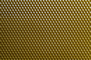 Bal dolu bir arı kovanından alınan balmumu bal peteğinin arka plan dokusu ve şablonu. Voshchina bal peteği yapımında yapay bir temel, hücrelerin balmumu tabakası