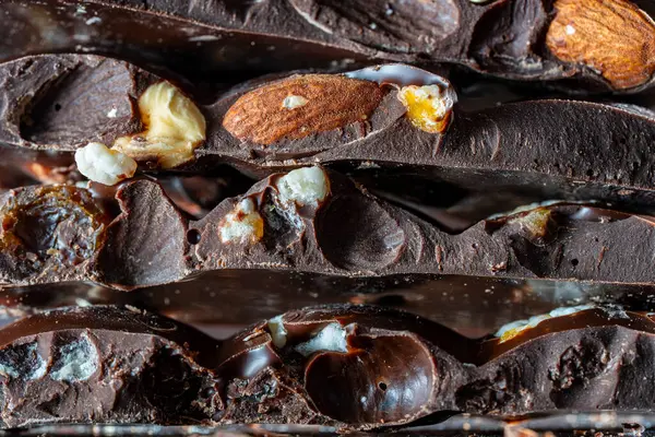 Pieces Dark Chocolate Candied Orange Raisins Almonds Hazelnuts Close — Stock Photo, Image