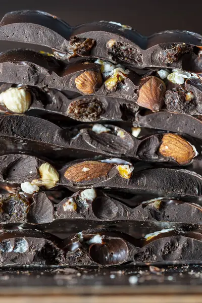 Pieces Dark Chocolate Candied Orange Raisins Almonds Hazelnuts Close — Stock Photo, Image