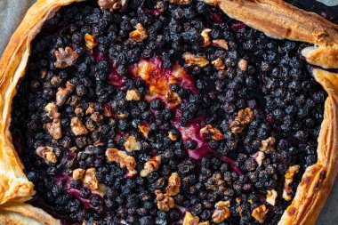 Kabartma kağıdında yaban mersinli ve cevizli poğaça turtası.