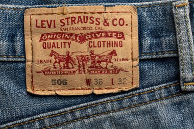 Kyiv, Ukraine - Oct 16, 2024 : Levi's Strauss blue jeans with brand leather tag. Levi Strauss is an American clothing company, selling classic vintage denim jeans. Classic Levis jeans label, closeup clipart