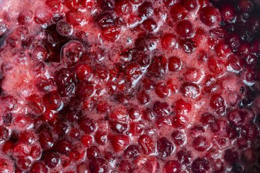 Bir reçel hazırlarken, kırmızı kızılcık bir tencerede, yakın çekim, üst manzara