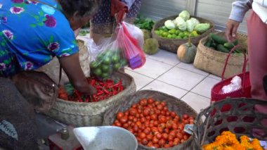 UBUD, BALI, INDONEZYA - 27 Nisan 2019: Endonezyalı fakir insanlar, Endonezya 'nın Bali adasındaki Ubud köyündeki sabah pazarında sağlıklı yiyecek satıyor ve satın alıyorlar. Sabah meyve ve sebze pazarı