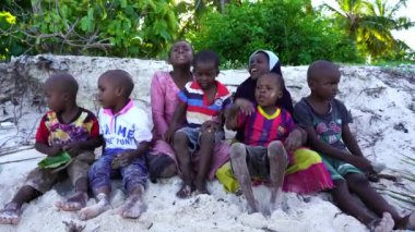 Zanzibar, Tanzania - december 12, 2019 : Young African girl and boy on the tropical beach in island of Zanzibar, Tanzania, east Africa, close up