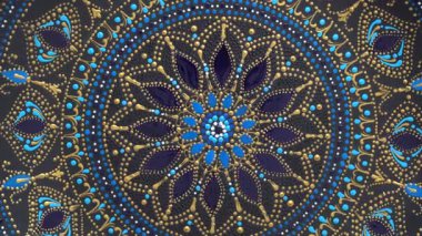 Dekoratif seramik tabak, siyah, mavi ve altın renkli, arka planda boyalı, yakın plan, üst manzara, döndürme. Akrilik boyalarla boyanmış dekoratif porselen tabaka, el işi, nokta boyası.