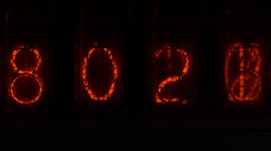 Retro vacuum tube display on the device counts seconds. Displaying numbers on a vintage lamp timer, close up, nixie tube indicator. Glow discharge indicator