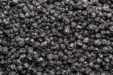 Kurutulmuş yaban mersini arka planı, yakın plan, üst manzara, makro. Kurutucudan bir yığın kuru yaban mersini. Kış için vitamin ve sağlıklı beslenme kavramı