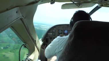 Arusha, Tanzania - december 28, 2019 : Man piloting a small civilian plane en route from Arusha to Zanzibar, Tanzania, east Africa. Male pilot in a plane cockpit, close up, slow motion