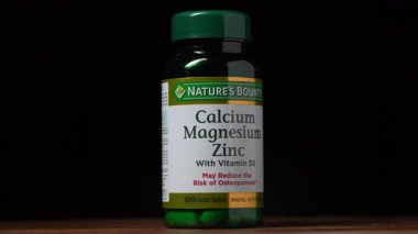 Kyiv, Ukraine - Dec 05, 2024 : Bottle with vitamins, supplements, microelements and minerals from Nature's Bounty company. Calcium, magnesium, zinc and vitamin D3 to reduce risk of osteoporosis