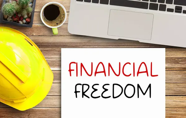 Business quotes, FINANCIAL FREEDOM on notebooks or paper in office desk, office workplace