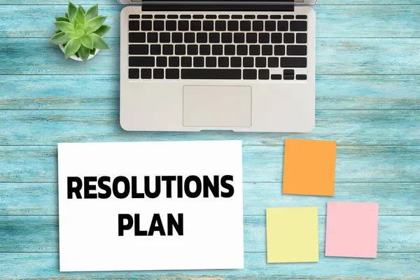 Business quotes, RESOLUTIONS PLAN on notebook or paper in office desk, office workplace