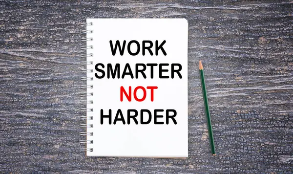 Business quotes, WORK SMARTER NOT HARDER on notebook or paper in office desk, office workplace, inspiration, motivation quotes concept.