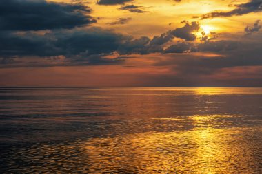 Beautiful cloudy sunset or sunrise over the sea