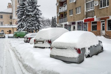 Cars in the city covered in snow after a heavy snowfall
