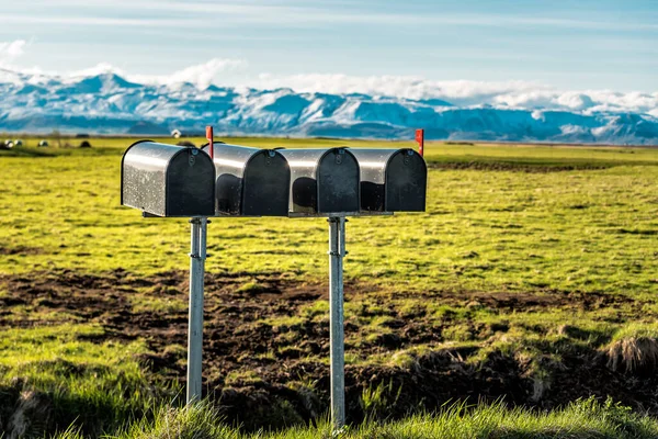 stock image Four black metal mailboxes and glacier in Iceland