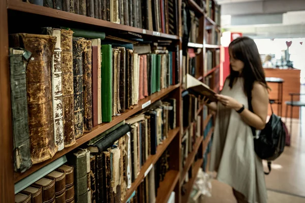 Woman in old vintage book store