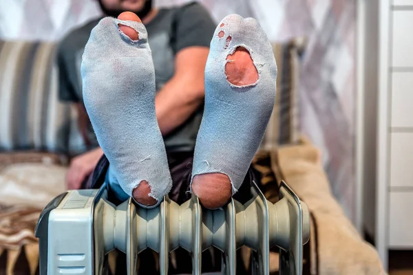 Brocken Worn Out Socks Human Man Legs Heating Radiator Concept Royalty Free Stock Photos