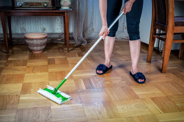 stock image Wooden laminate parquet floor cleaning with mop, home maintenance