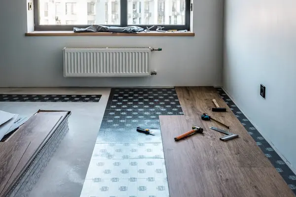 Installation of laminate or vinyl floor, Different tools. Industrial theme