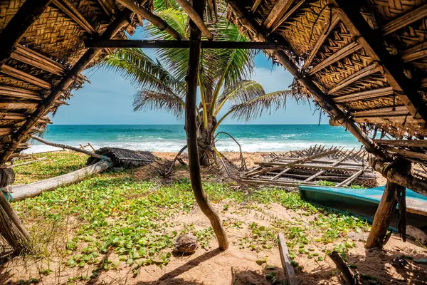 View from Palm cover protect roof barn, hut, tent, shelter on the tropical ocean beach. Travel and vacation theme