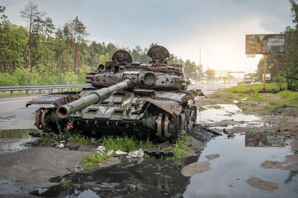 Wreck of burnt russian rusty tank in Ukraine. Russian aggression in Ukraine