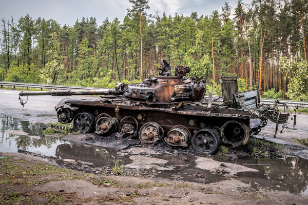 Wreck of completely burnt rusty russian tank in Ukraine. Russian aggression in Ukraine