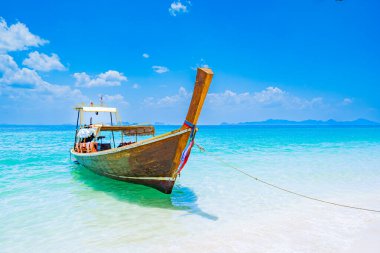 Sea, sandy beach with long tail boats on the beach of Kradan island or Koh Kradan, Trang Province, southern Thailand, Asia clipart