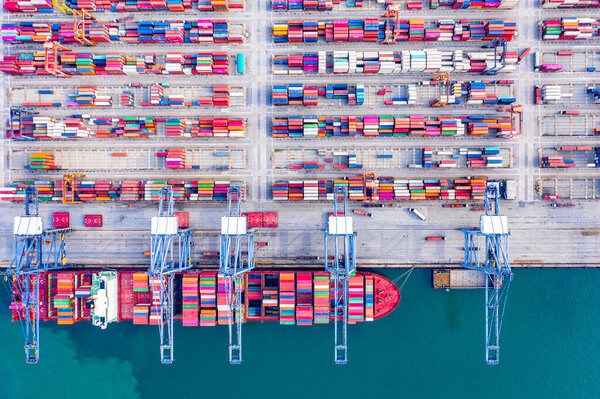 Deep-sea port, cargo ships dock, transport goods, containers load and unload ships, import and export goods.