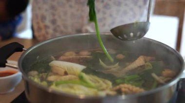 Elektrikli tencerede shabu shabu ya da sukiyaki sebze çorbası yemek. Sıcak Çömlek