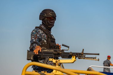 Makineli tüfekli araçtaki askerler.