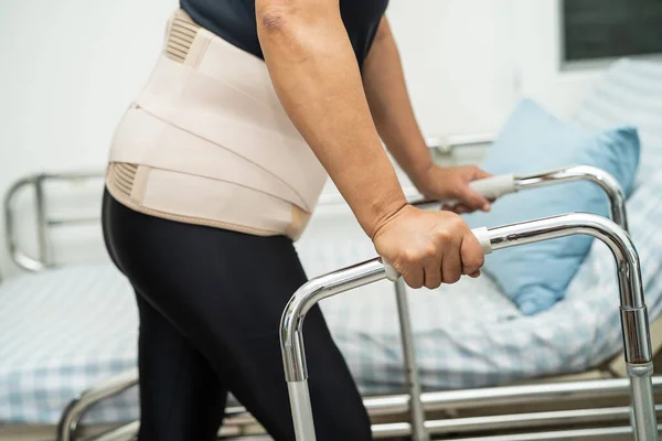 stock image Asian lady patient pain her back, waist and orthopedic lumbar with walker.