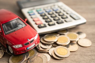Bangkok, Thailand, June 1, 2022 Car on stack of coins. Car loan, Finance, saving money, insurance and leasing time concepts.