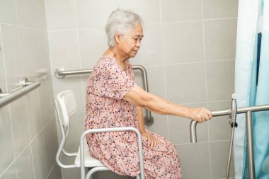 Asyalı yaşlı yaşlı kadın hasta, hemşire hastanesi koğuşunda tuvalet temizliği yapıyor. Sağlıklı güçlü tıbbi konsept..