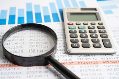 Grafikler üzerinde büyüteç hesap makineli çizelgeler. Mali kalkınma, Bankacılık Hesabı, İstatistikler, Yatırım Analitik Araştırma Veri Ekonomisi.