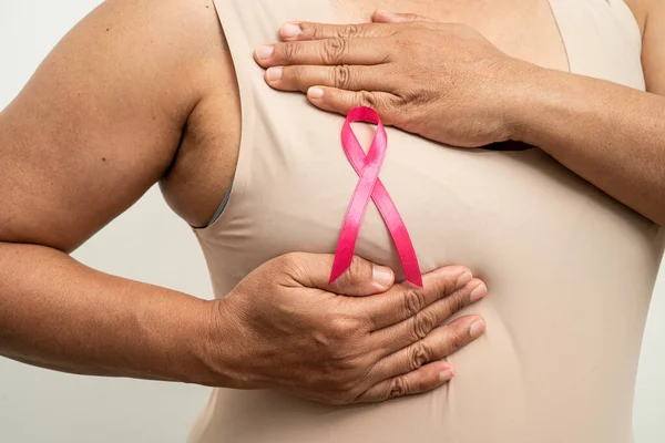 stock image Breast cancer, pink ribbon at Asian senior lady for supporting awareness, symbol of World Breast Cancer Day.