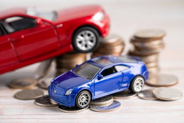 Bangkok, Thailand, June 1, 2022 Car on stack of coins. Car loan, Finance, saving money, insurance and leasing time concepts.