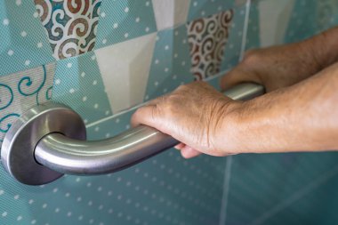 Asian senior or elderly old lady woman patient use toilet bathroom handle security in nursing hospital, healthy strong medical concept.