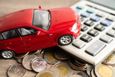 BANGKOK, THAILAND - FEBRUARY 12, 2023, Car on coins background; Car loan, Finance, saving money, insurance and leasing time concepts.
