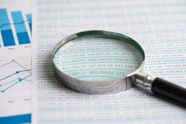 Magnifying glass on graph paper. Financial development, Banking Account, Statistics, Investment Analytic research data economy, Business concept.