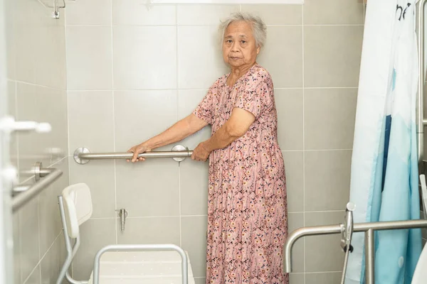 stock image Asian senior or elderly old lady woman patient use toilet bathroom handle security in nursing hospital, healthy strong medical concept.