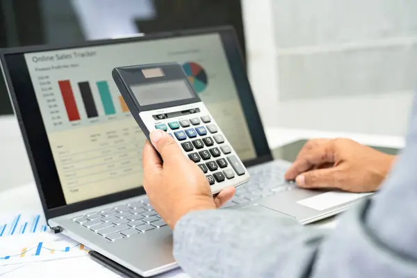 stock image Asian accountant working and analyzing financial reports project accounting with chart graph and calculator in modern office, finance and business concept.