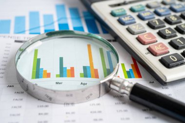 Magnifying glass on graph paper. Financial development, Banking Account, Statistics, Investment Analytic research data economy, Business concept.