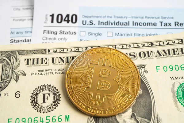 stock image Tax Return form 1040 with bitcoin and dollar banknote, U.S. Individual Income.